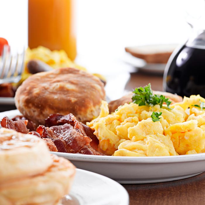 Fresh baked biscuits, scrambled eggs, bacon, waffles and hot coffee served for breakfast at Wheaton Family Restaurant in Eau Claire, WI